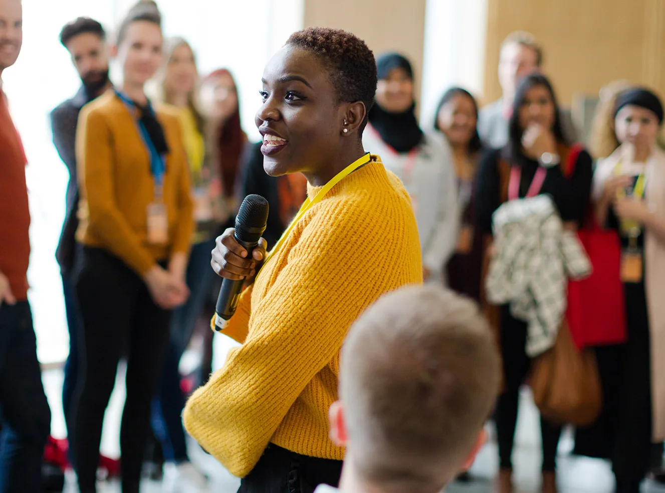 Female speaker with microphone on stage